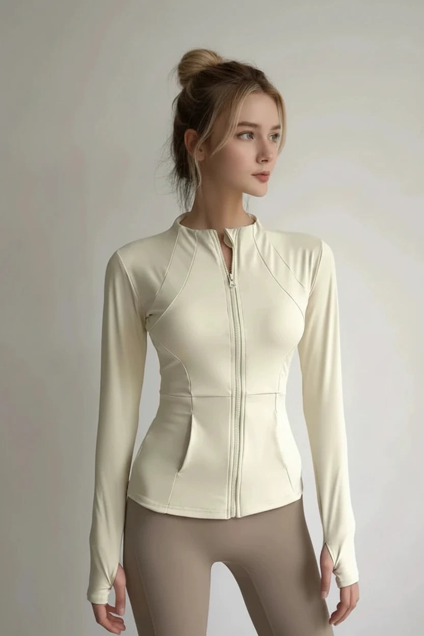 Beige long-sleeve athletic jacket worn by a person on a plain background
