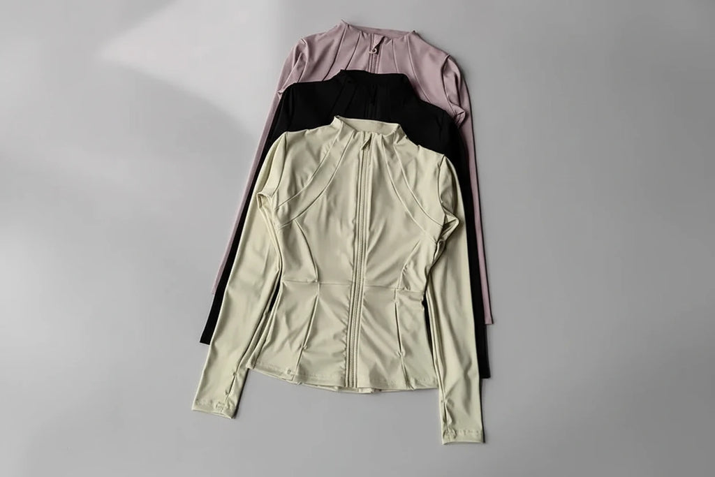 Three jackets in different colors on a gray background