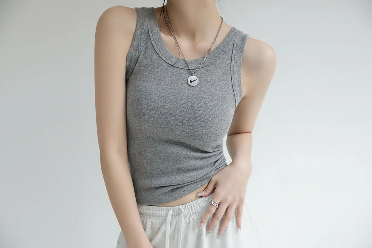 Gray tank top worn by a person with text highlighting design features.